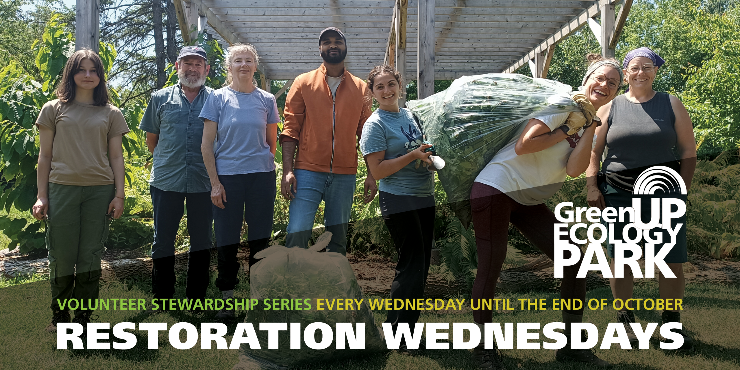 A group of eight volunteers pose in front of a garden structure with bags of invasive species they removed from the woodland at Ecology Park.